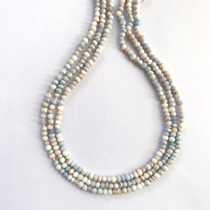 Faceted rondelle lavender opal beads strung on a 32cm strand glowing in soft purple hues.