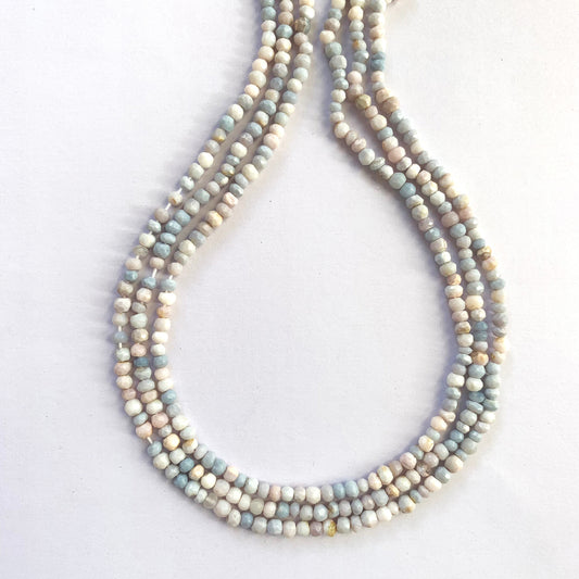 Faceted rondelle lavender opal beads strung on a 32cm strand glowing in soft purple hues.