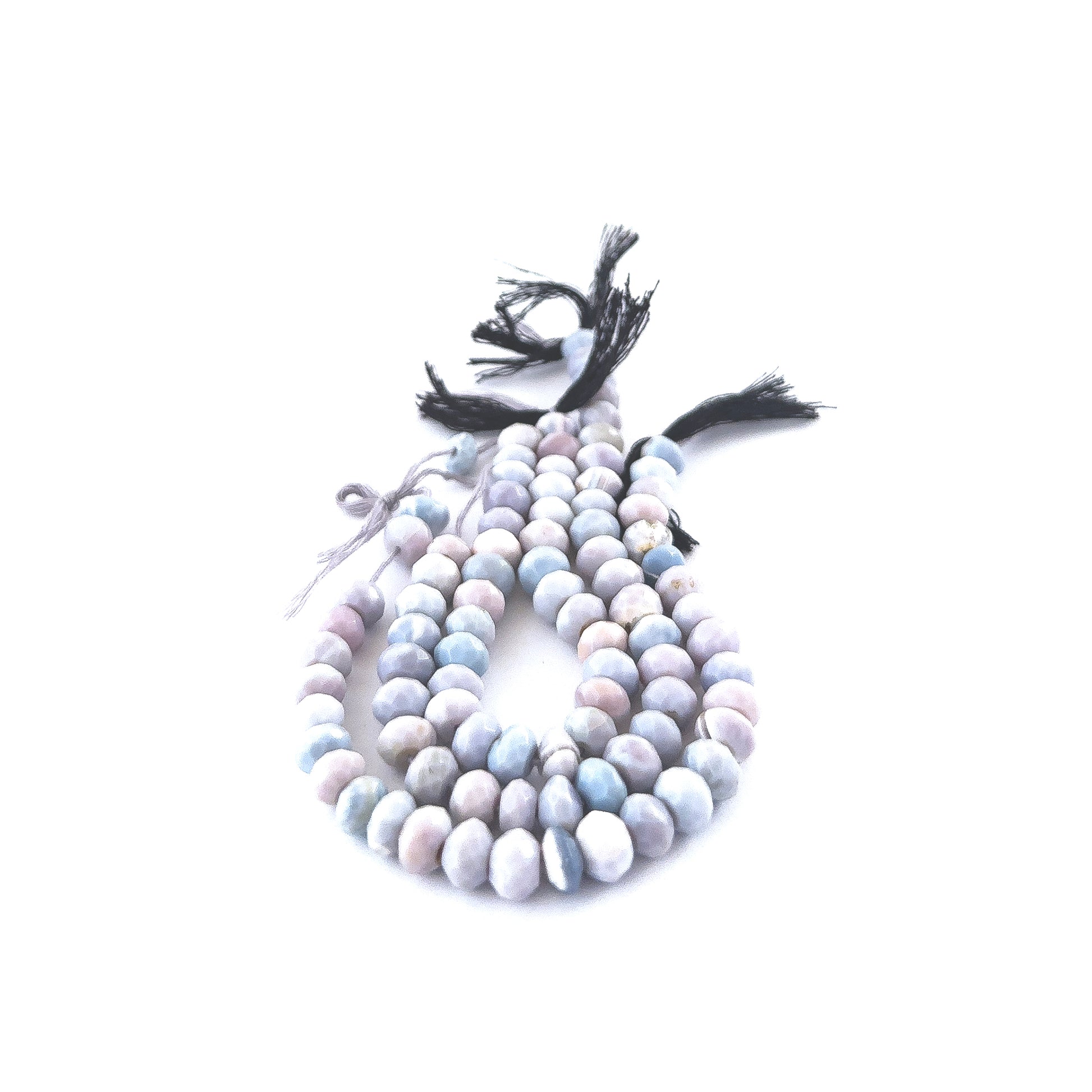 Close‑up of Lavender Opal faceted rondelle beads highlighting their reflective facets and delicate purple tones.