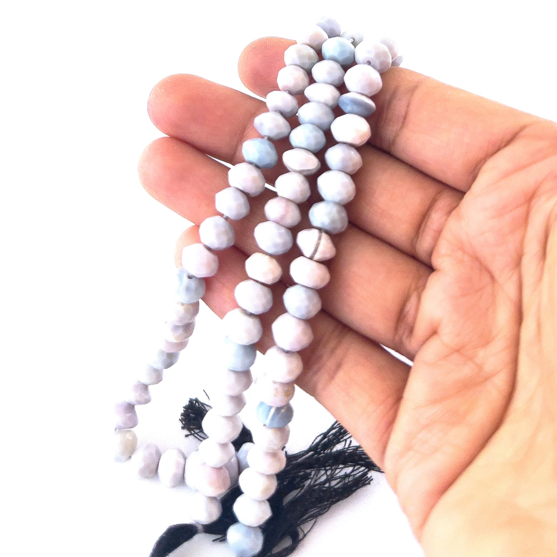 Lavender Opal gemstones in faceted rondelle form, offering bright reflective shine and smooth pastel colouring.