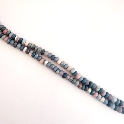 Lavender Opal beads laid out in rondelle formation showing natural variation and shine.