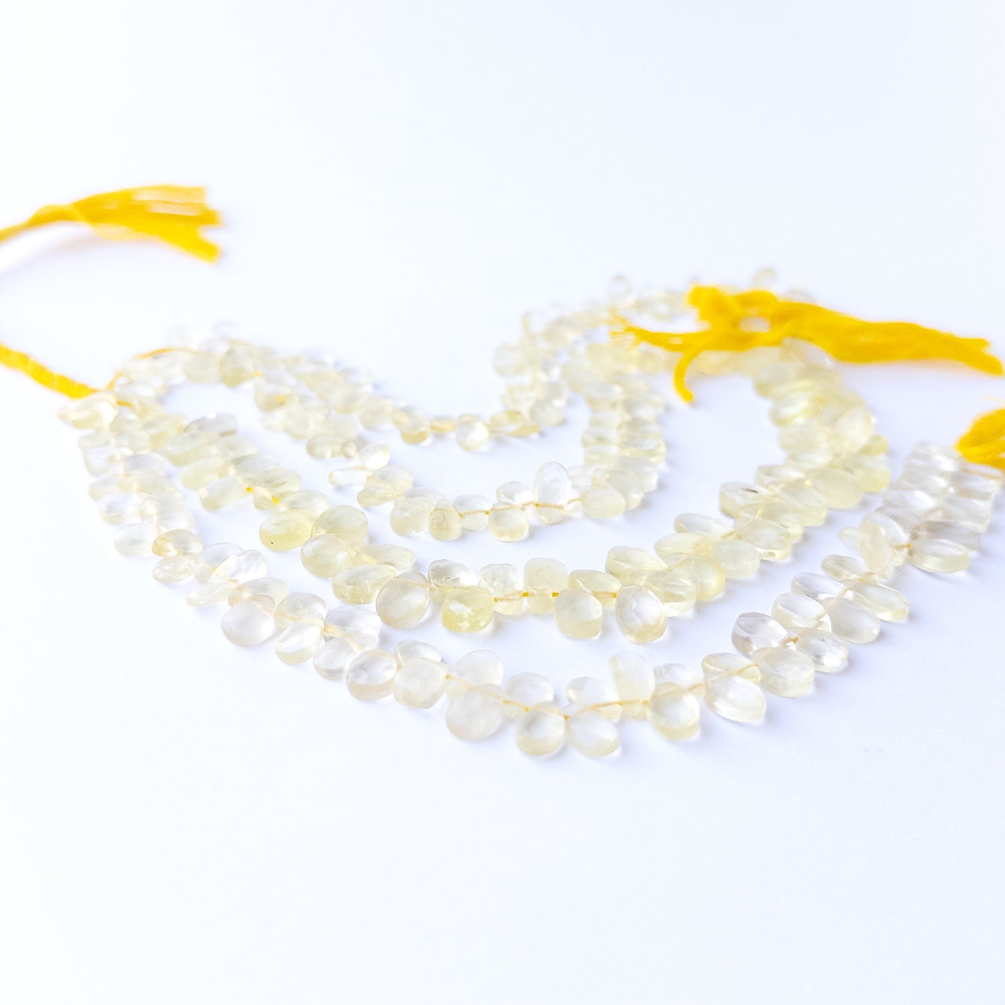 Vibrant Lemon Quartz gemstone beads with 4.5–6.5mm faceted briolette cut and polished brilliance.