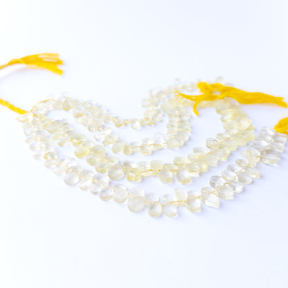 Vibrant Lemon Quartz gemstone beads with 4.5–6.5mm faceted briolette cut and polished brilliance.