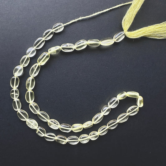 Natural gemstone beads featuring Lemon Quartz with polished finish and elongated oval cut.