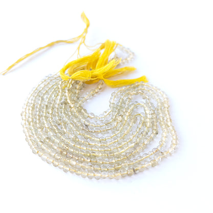 Lemon Quartz smooth round gemstone beads in 3.8–4mm size arranged on a 32cm strand with bright yellow clarity.