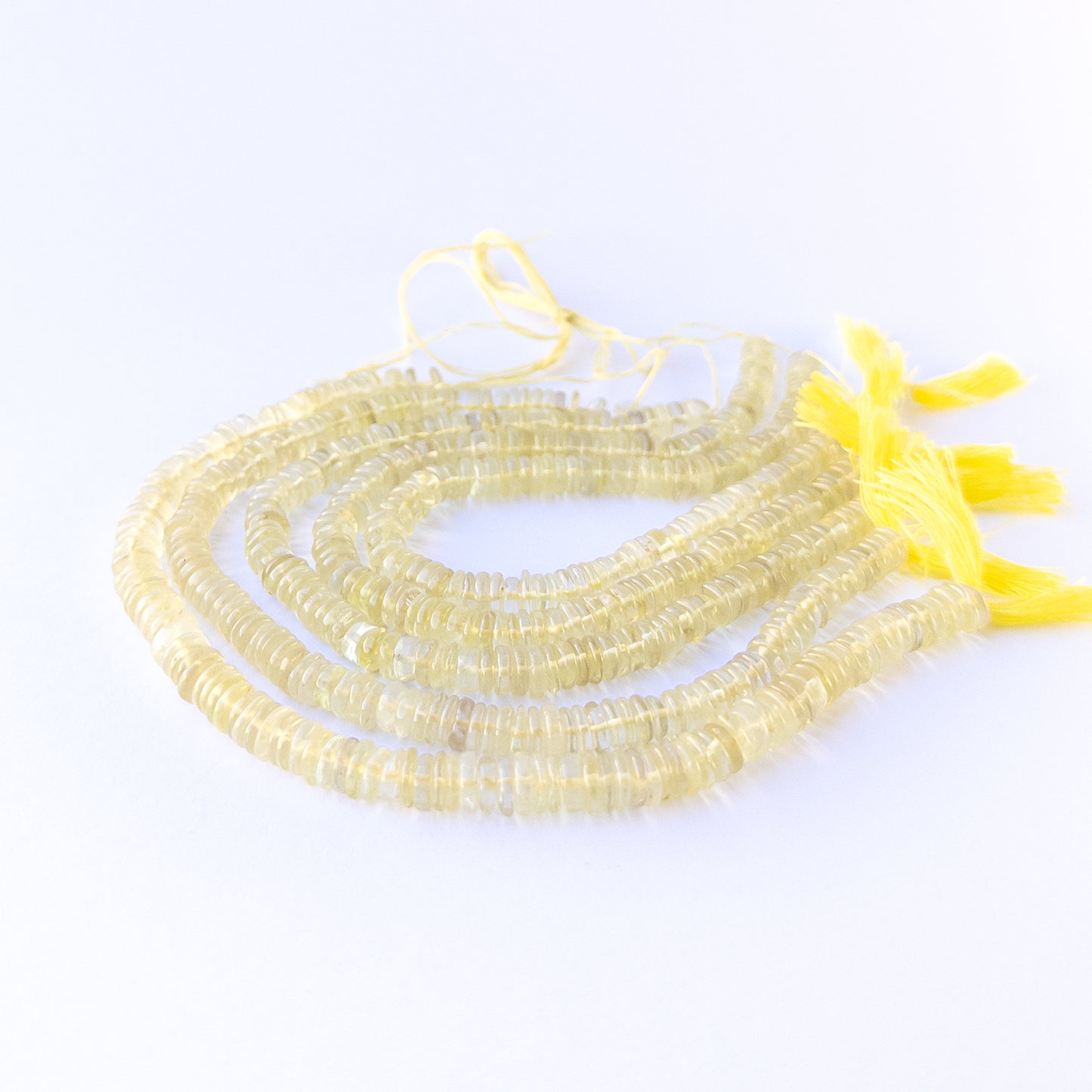 Premium lemon quartz gemstone beads for DIY jewellery, displaying smooth wheel cuts and fresh sunny colour.
