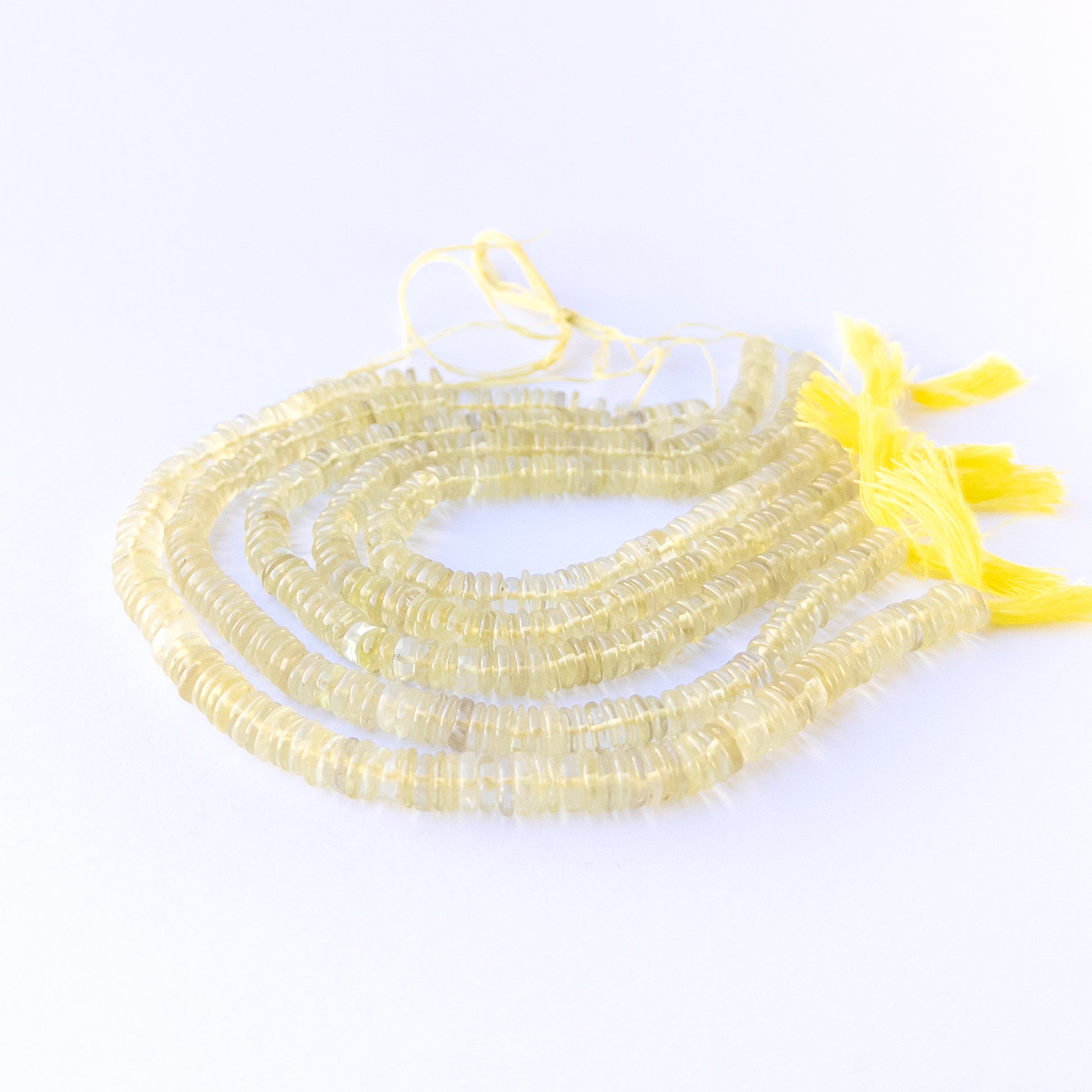 Premium lemon quartz gemstone beads for DIY jewellery, displaying smooth wheel cuts and fresh sunny colour.