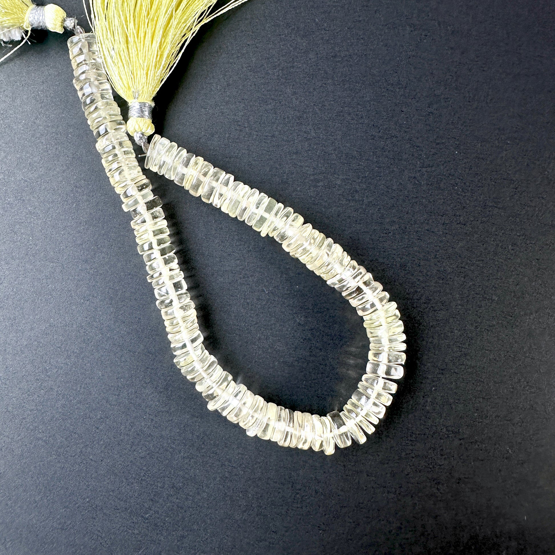 Close-up of Lemon Quartz beads showcasing their glossy surface and vibrant colour.