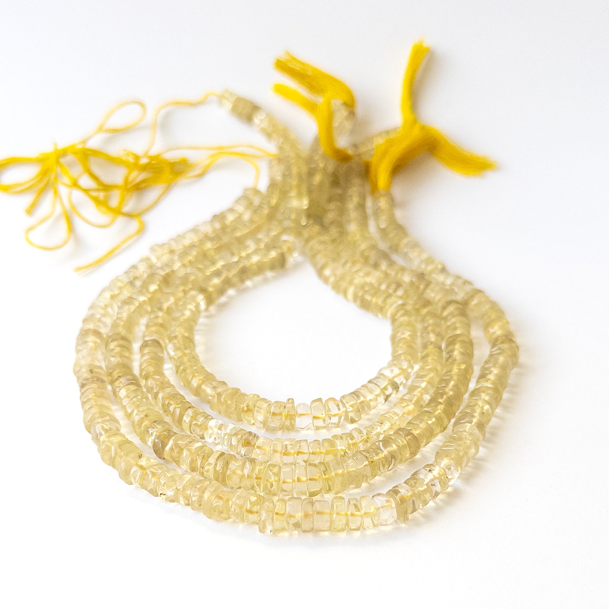 Lemon Quartz smooth wheel gemstone beads in 6–7.5mm sizes, genuine stone beads for handmade jewellery.