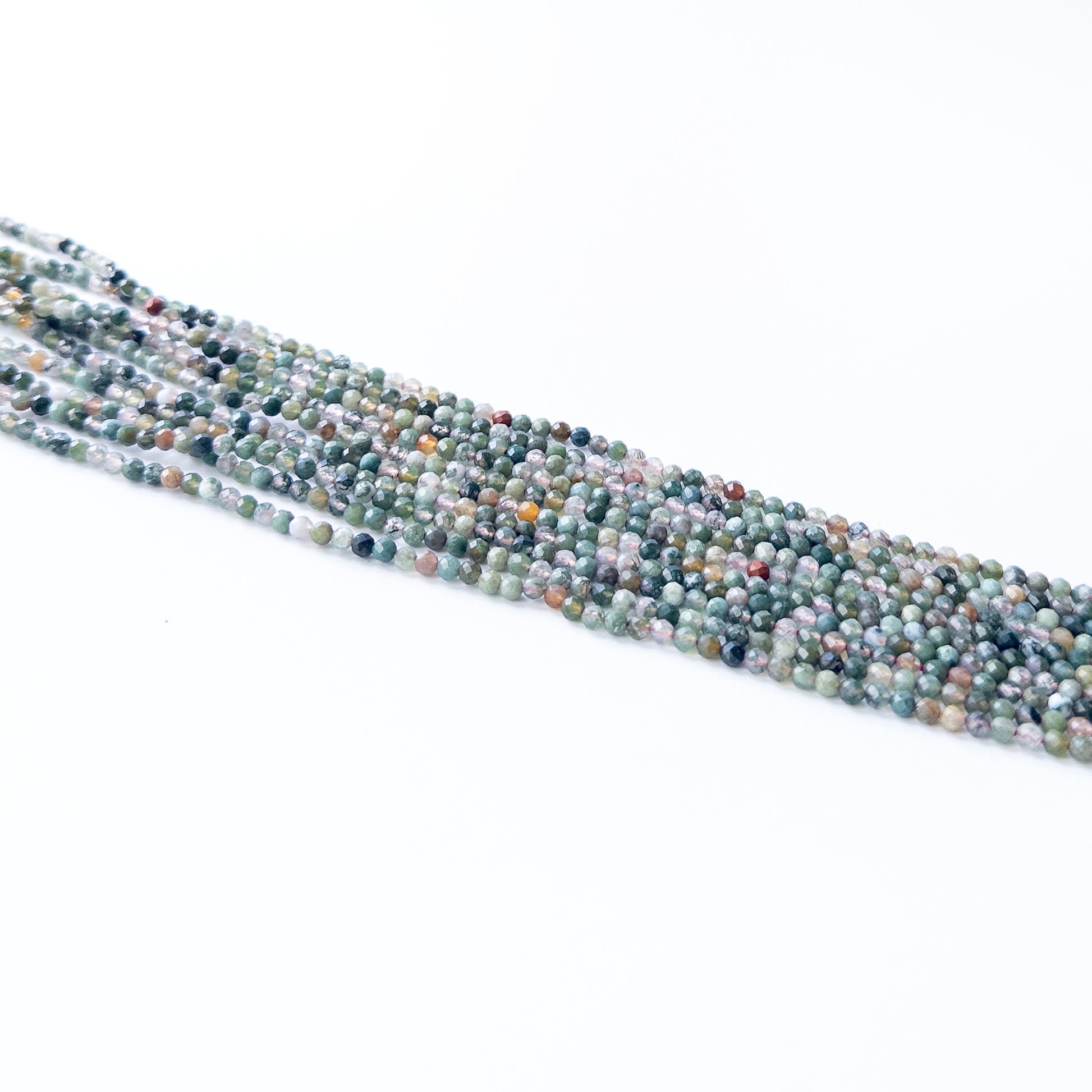 Handmade jewellery components featuring natural Mixed Agate faceted rondelles, highlighting their vibrant colours and bright shine.