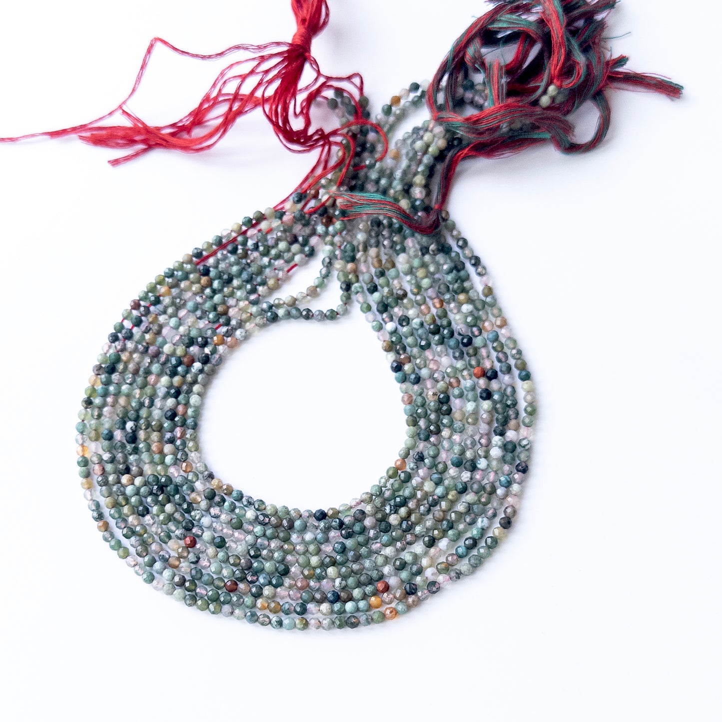 Genuine Mixed Agate gemstone beads displaying multicolour tones, polished facets, and a neatly arranged 31cm strand for jewellery design.