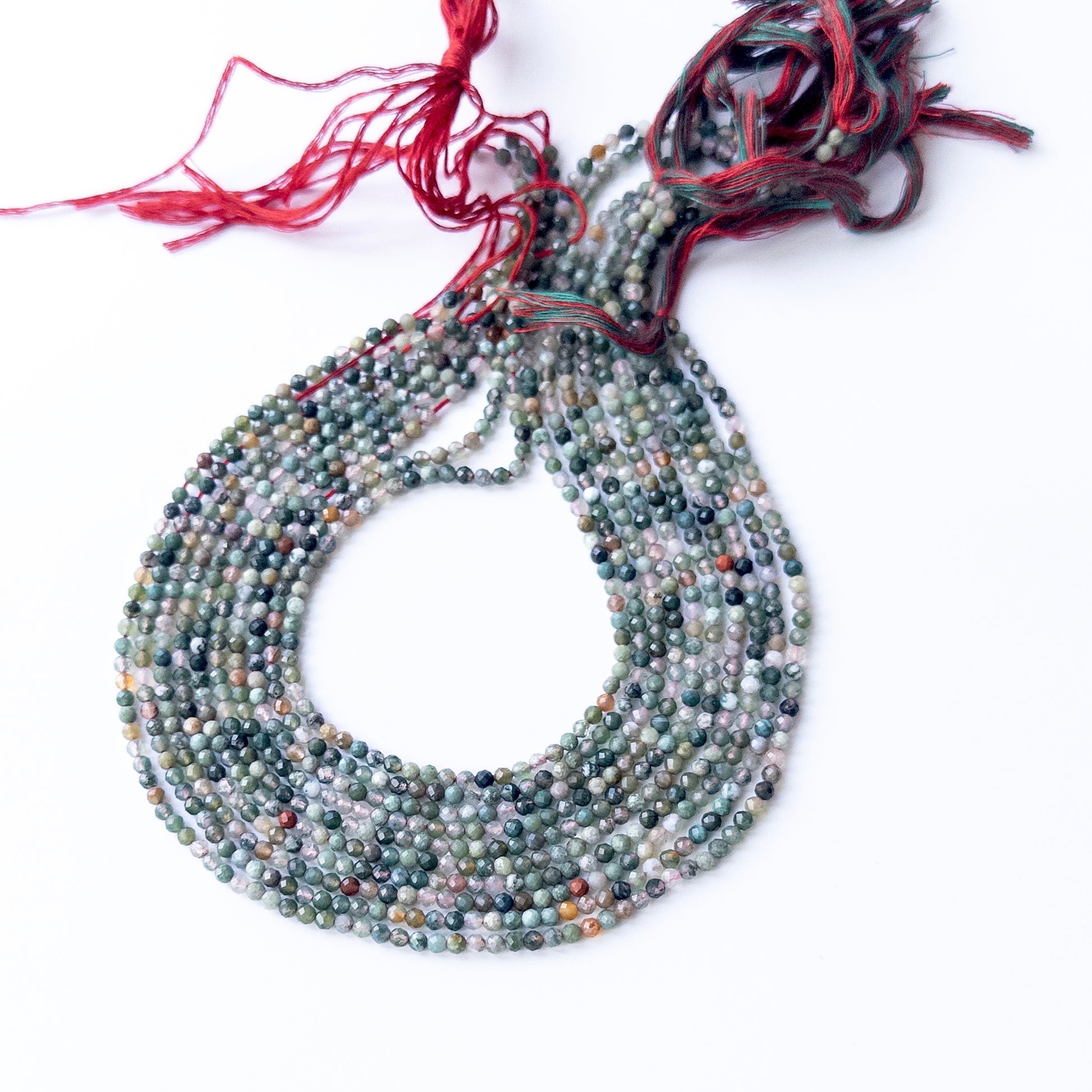 Genuine Mixed Agate gemstone beads displaying multicolour tones, polished facets, and a neatly arranged 31cm strand for jewellery design.