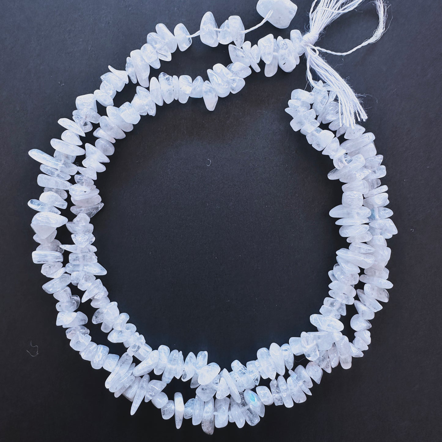Natural gemstone beads featuring Moonstone chips with organic shapes and subtle shimmer.