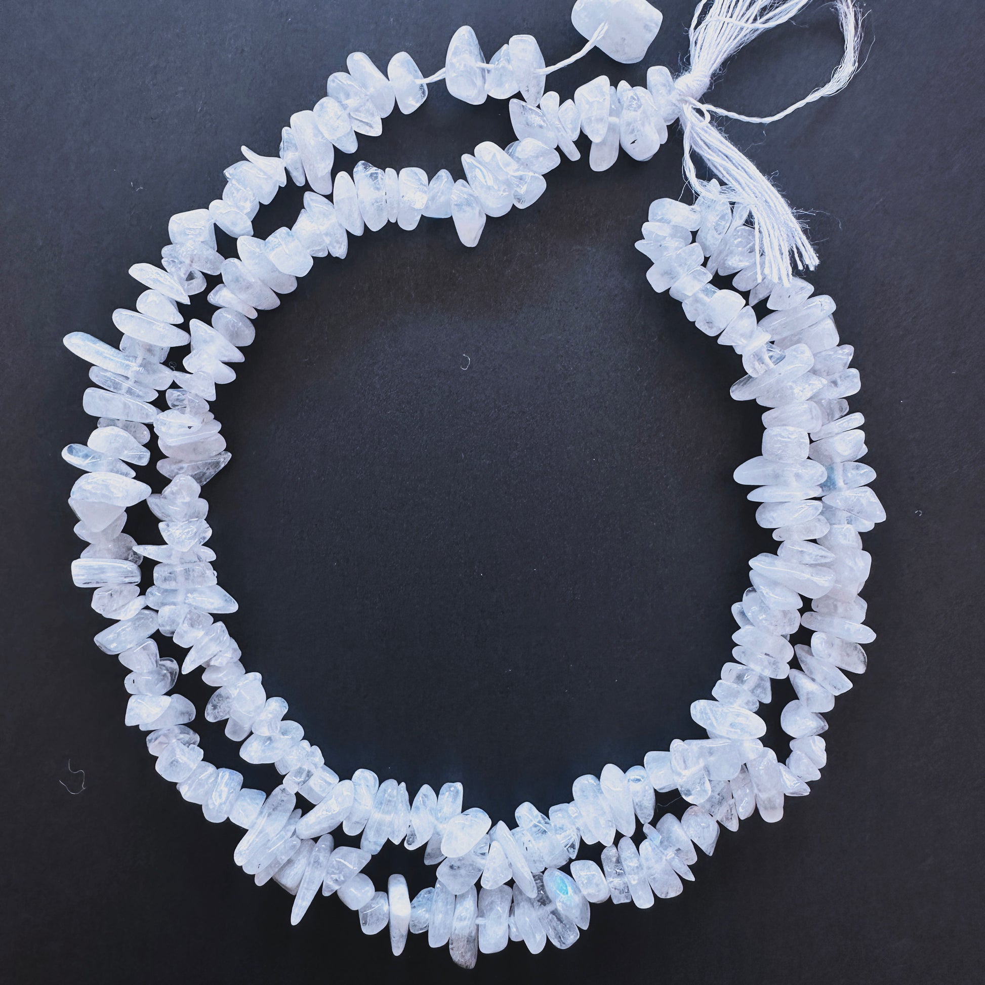 Natural gemstone beads featuring Moonstone chips with organic shapes and subtle shimmer.