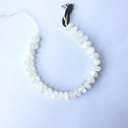 Moonstone beads arranged in a strand with consistent cut and luminous colour.