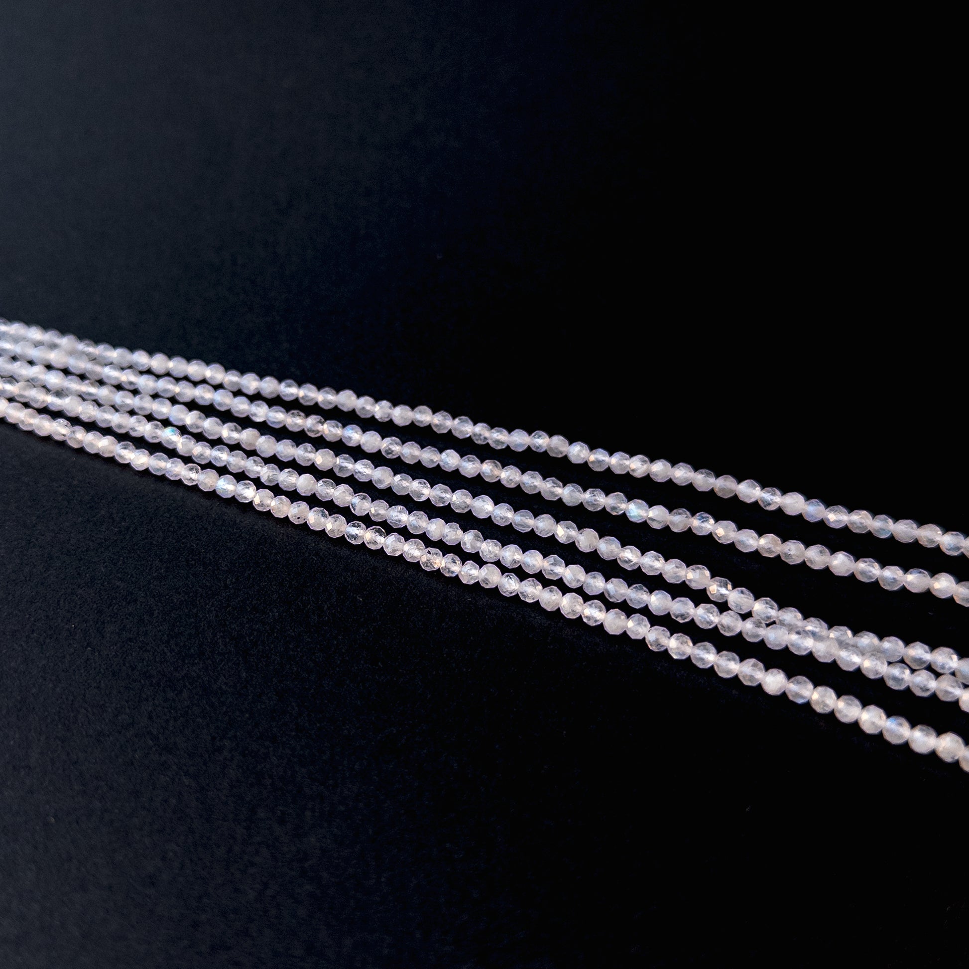 Handmade jewellery components featuring natural moonstone faceted rondelles with luminous tones and polished sparkle.