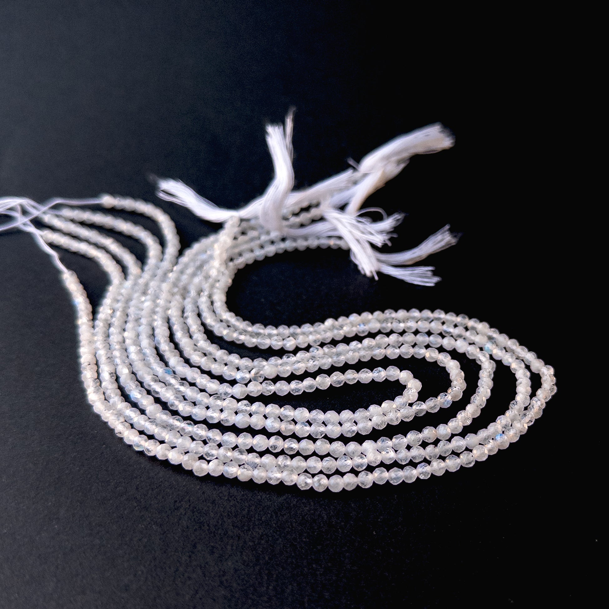 Genuine stone beads with soft white and rainbow flashes, featuring faceted rondelles for DIY jewellery making.