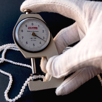 A dial gauge measures the Moonstone faceted rondelle 3.4mm gemstone.