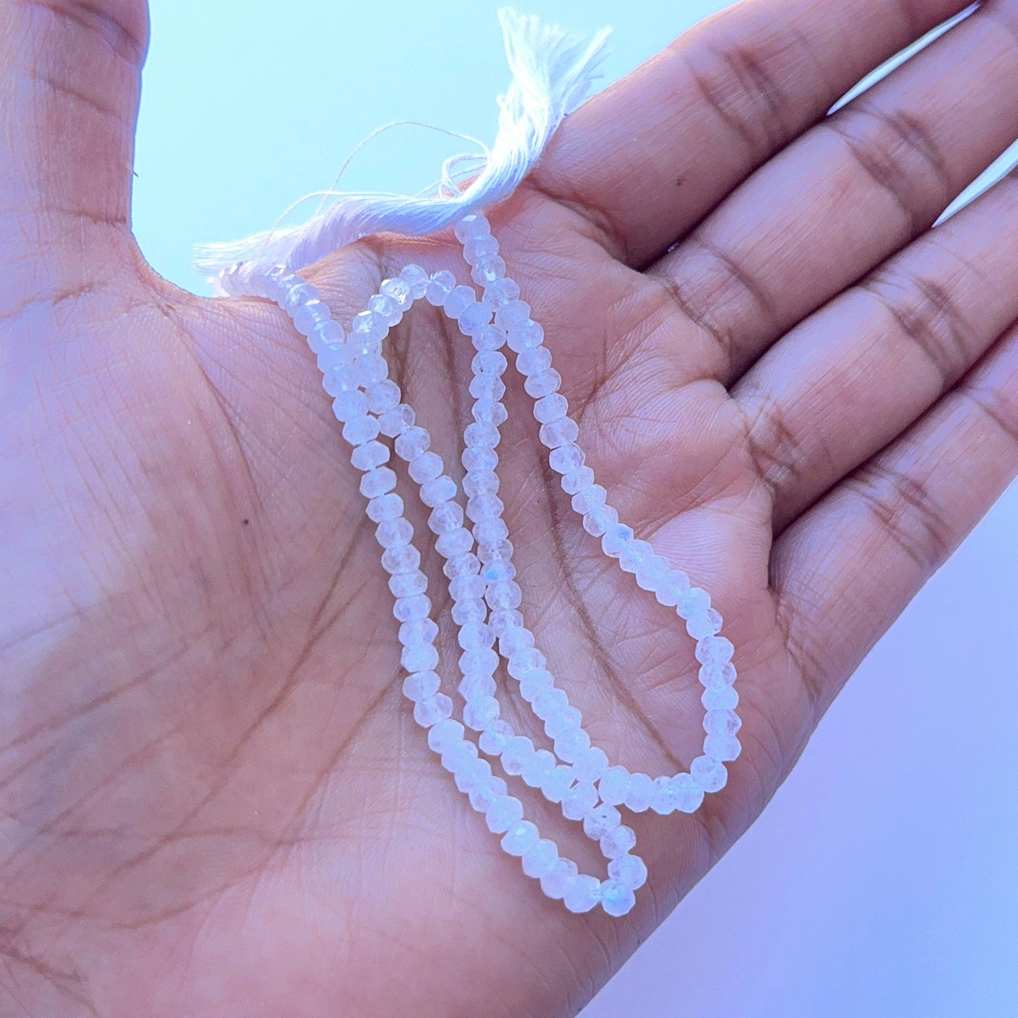 Moonstone faceted rondelle natural gemstone beads with soft shimmer arranged on a 33cm strand for handmade jewellery components.