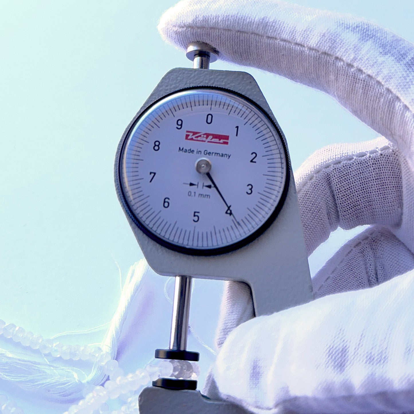 A dial gauge measures the Moonstone faceted rondelle 3.8mm gemstone.