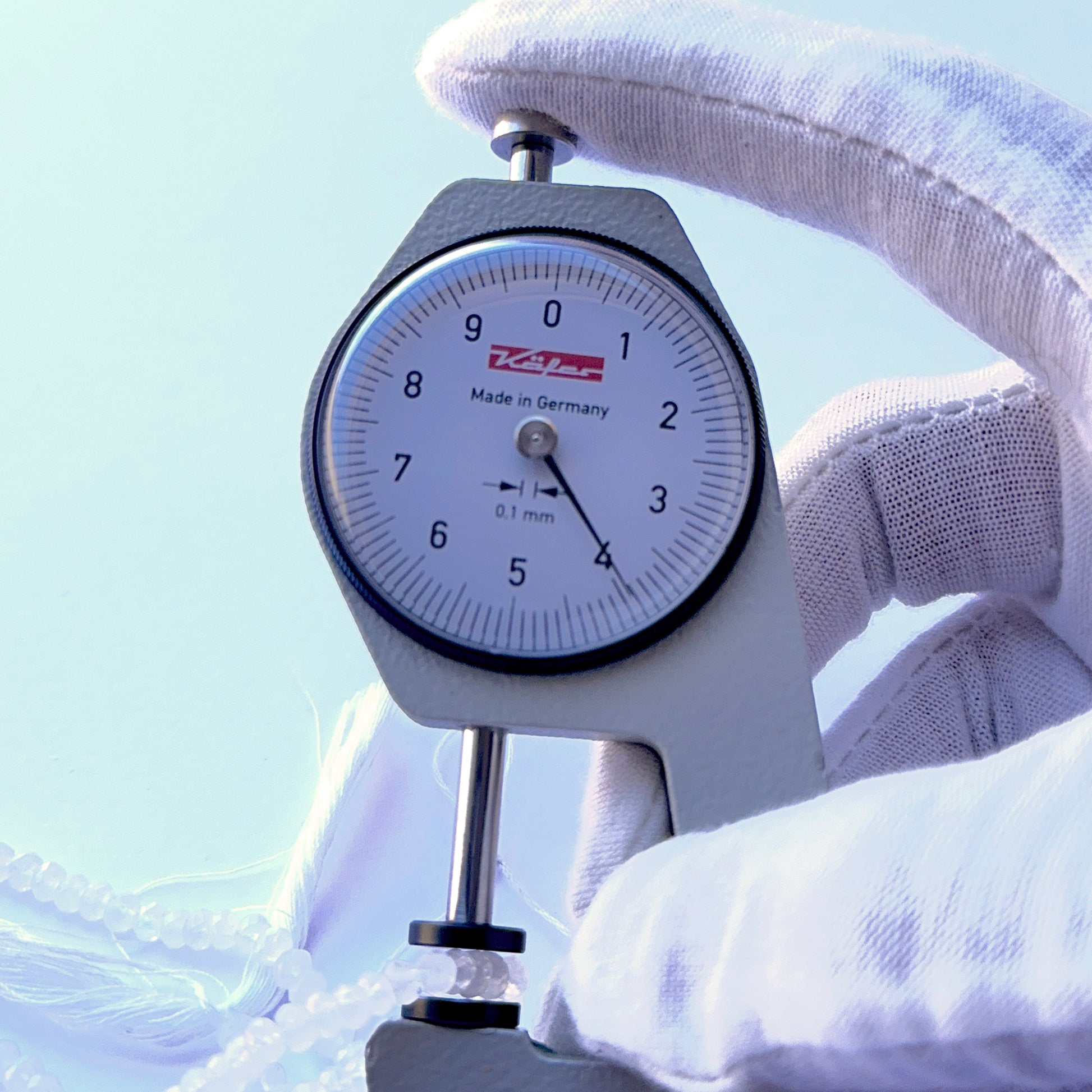 A dial gauge measures the Moonstone faceted rondelle 3.8mm gemstone.