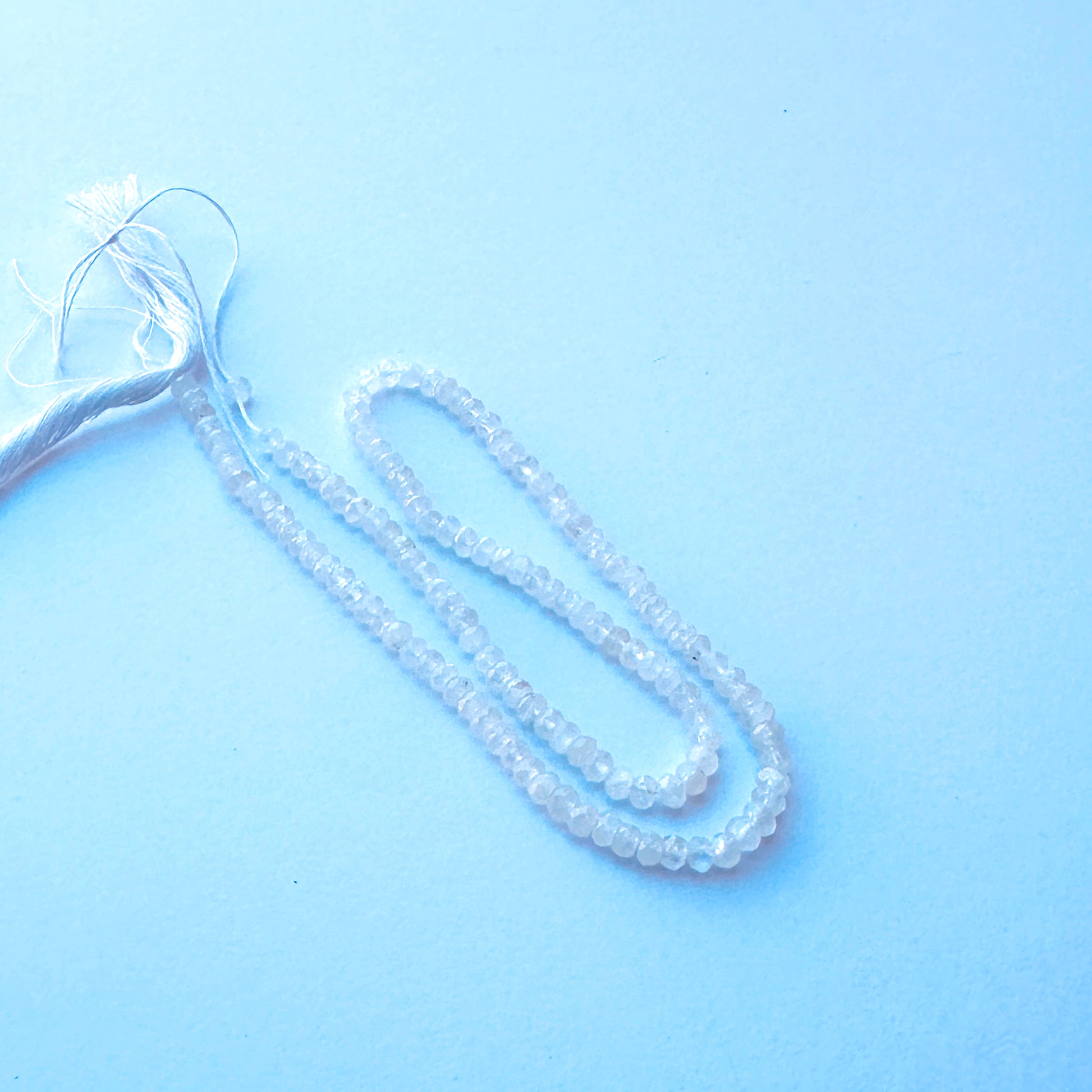 Detailed view of premium Moonstone stone beads showing consistent 3.8mm sizing, faceting and luminous colour.