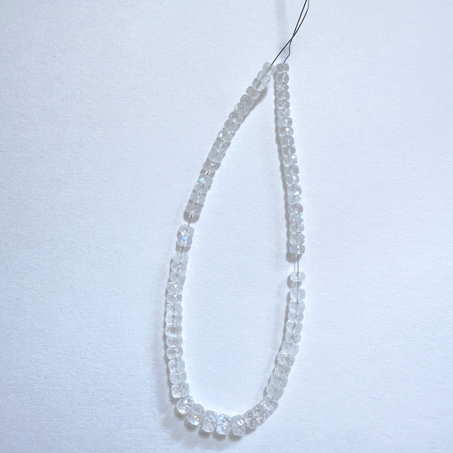 Moonstone faceted rondelle beads in 4-5.5mm size with soft shimmer and polished finish on a 20cm strand.