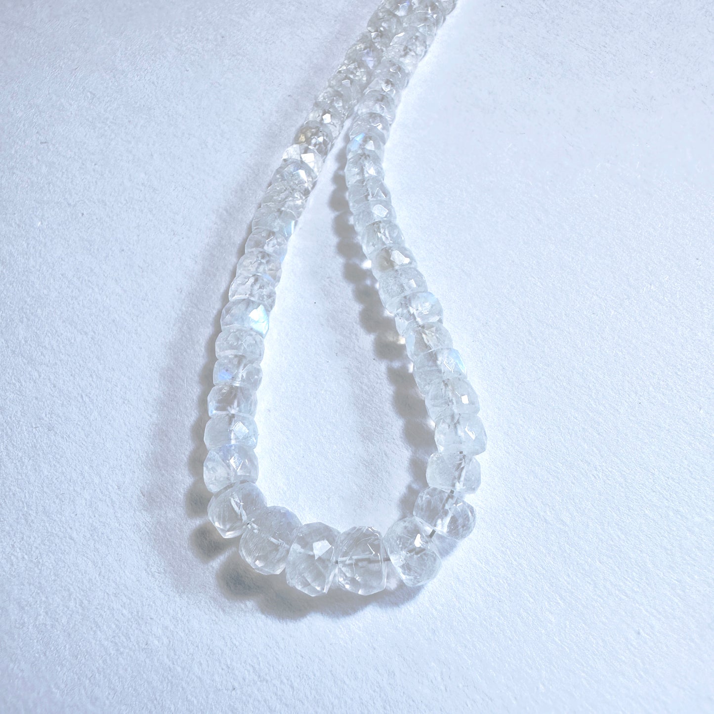 Stone Beads with iridescent glow and faceted rondelle shape, ideal for custom jewellery designs.