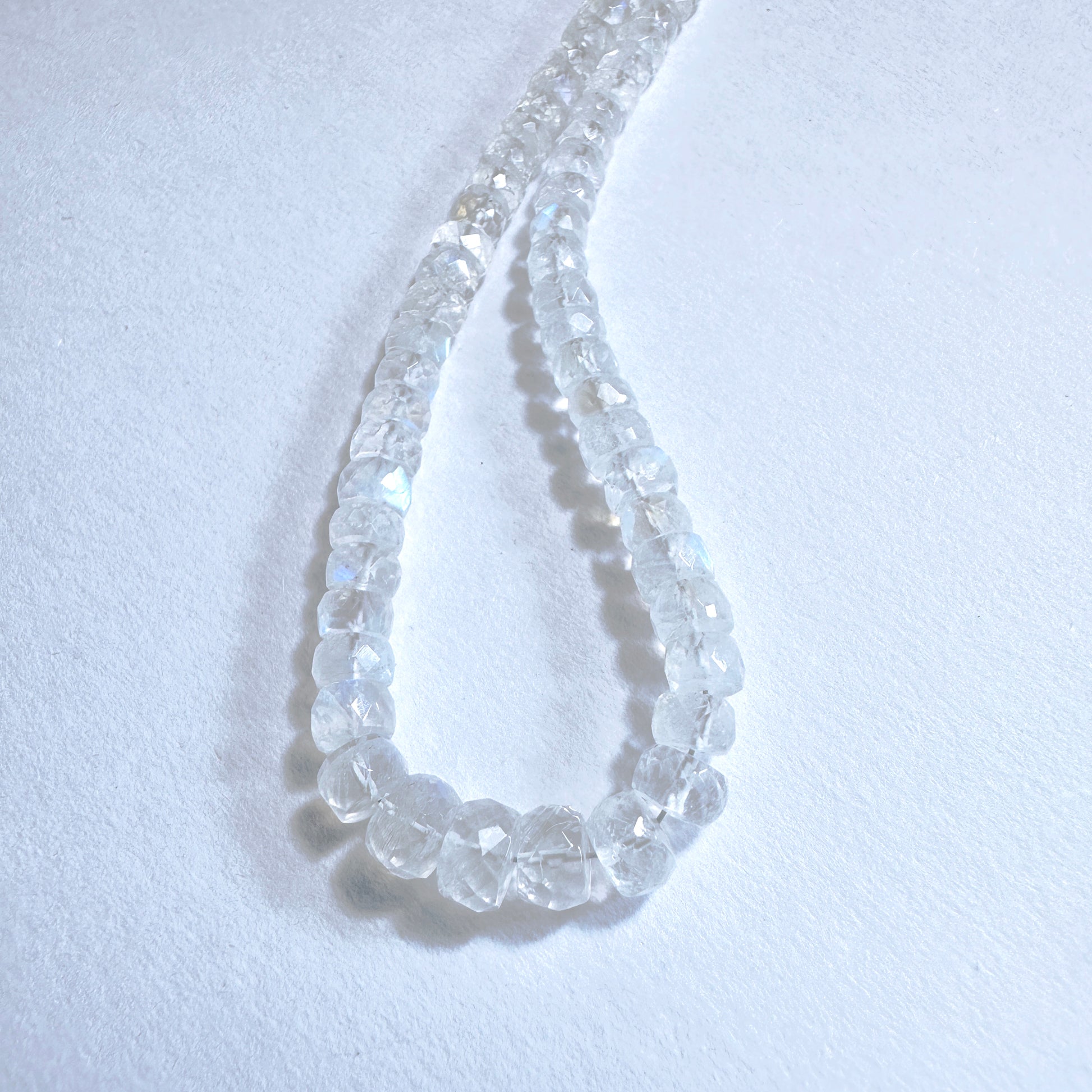 Stone Beads with iridescent glow and faceted rondelle shape, ideal for custom jewellery designs.