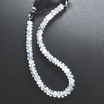 Close-up of Moonstone beads showcasing their shimmering hues and detailed cut.