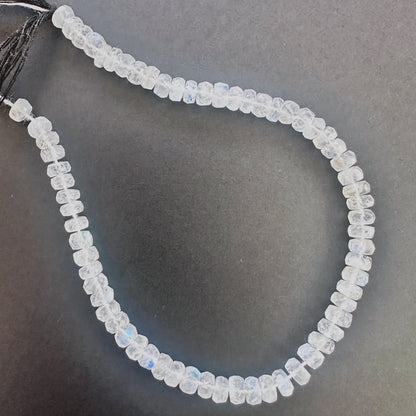 Close-up of Moonstone faceted rondelle beads with luminous white tones and blue sheen.