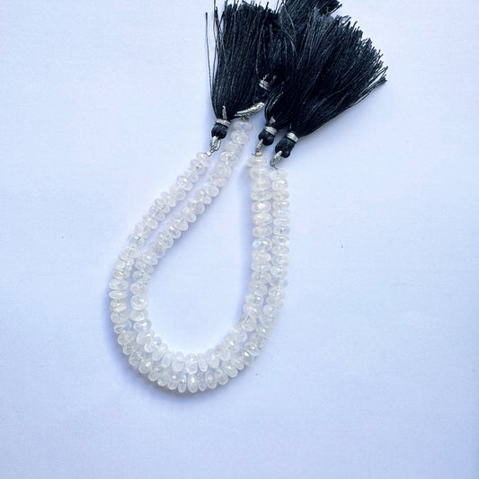 Moonstone beads with faceted rondelle cut arranged on a 20cm strand, glowing with soft hues.
