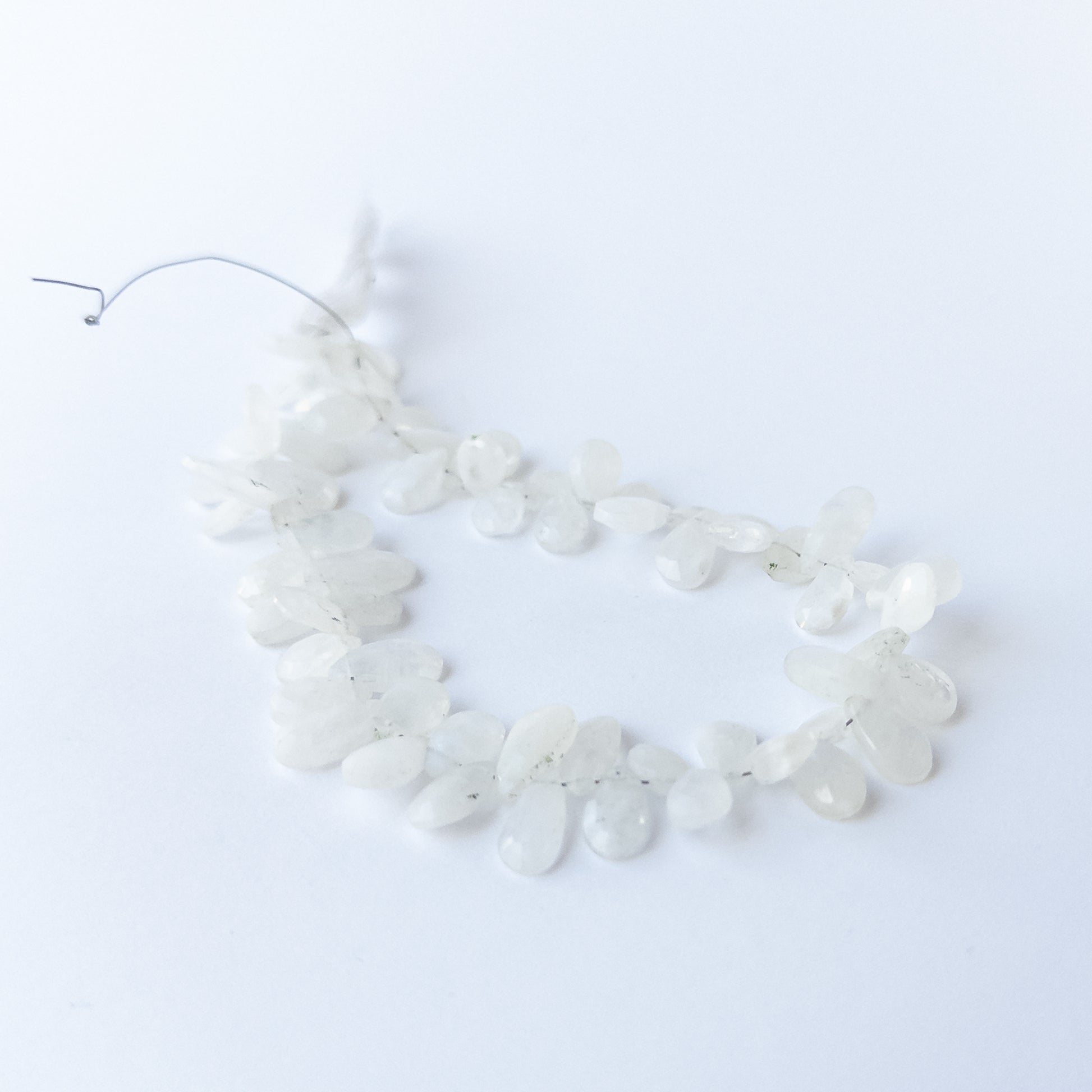 Rainbow Moonstone faceted briolette beads with natural glow, perfect for DIY jewellery makers using gemstone beads.