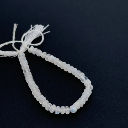 Moonstone smooth rondelle beads aligned on a strand highlighting clarity, shine and consistent sizing.