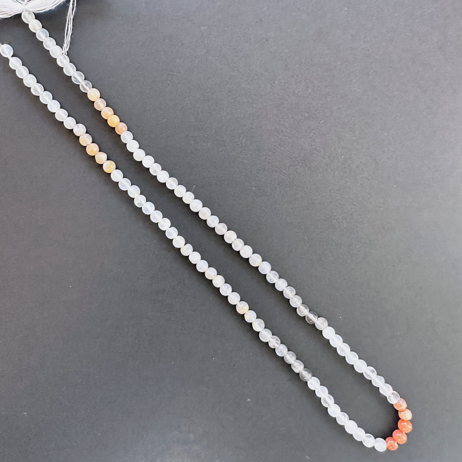 Moonstone stone beads with smooth round cut and luminous sheen.