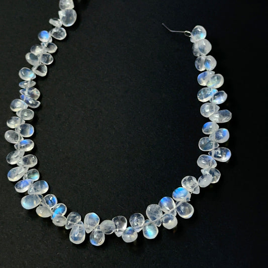 Moonstone smooth teardrop beads with soft glow, showcasing 6–7mm × 4.5–5mm stone beads ideal for DIY jewellery.