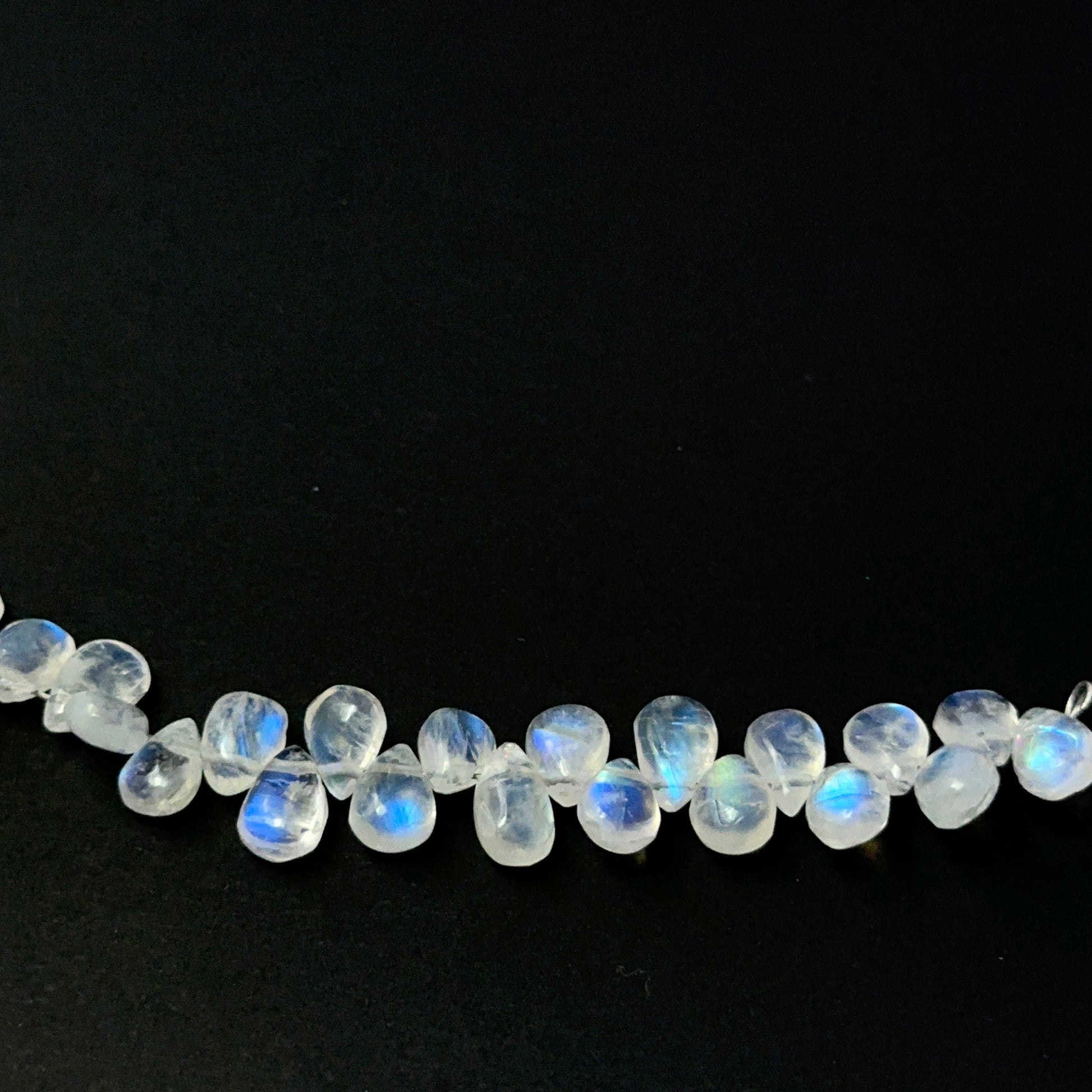 Shimmering Moonstone teardrop‑cut beads with gentle shine, perfect for genuine gemstone beads in creative designs.