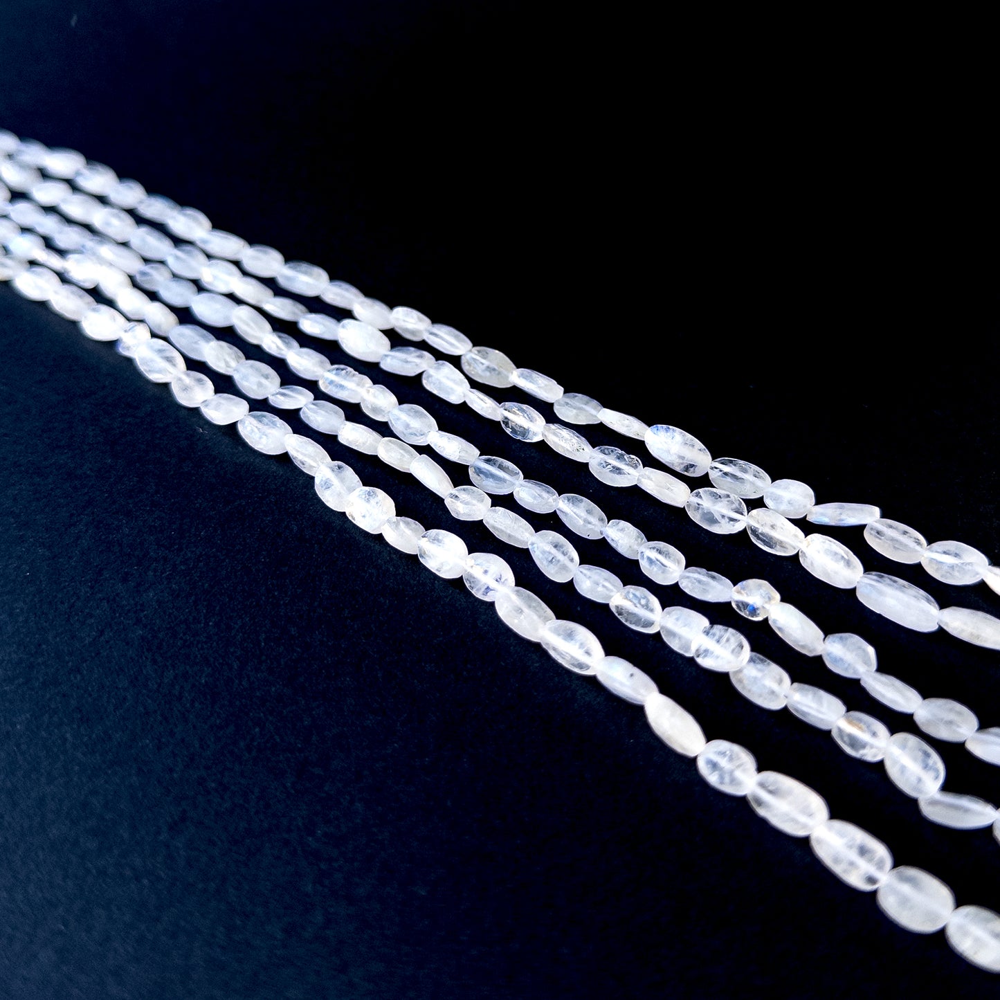 Handmade jewellery components featuring natural moonstone smooth tumbles with luminous tones and polished glow.