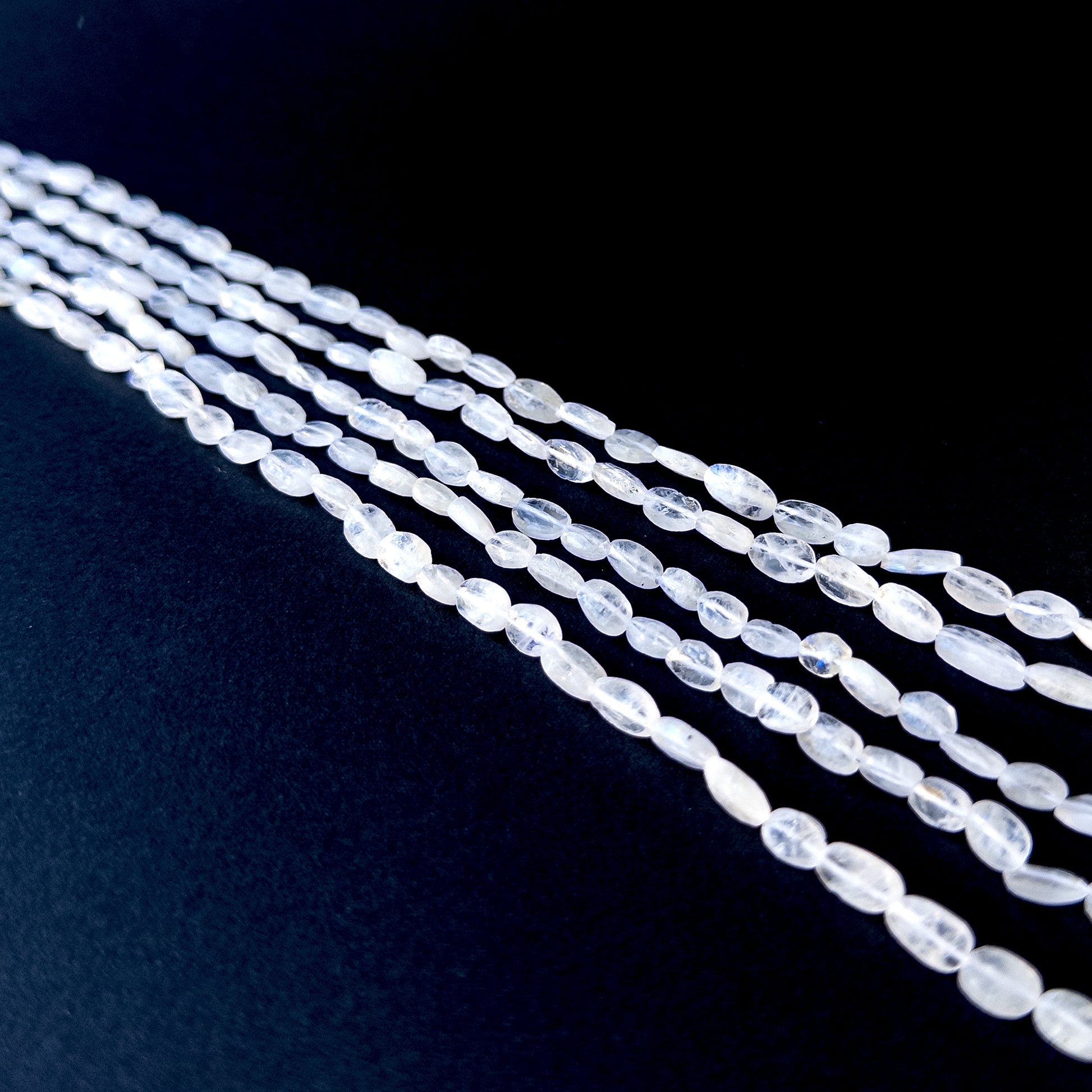 Handmade jewellery components featuring natural moonstone smooth tumbles with luminous tones and polished glow.