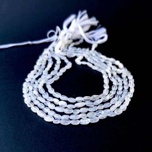 Genuine stone beads with soft white tones and rainbow flashes, featuring smooth tumbles for DIY jewellery making.