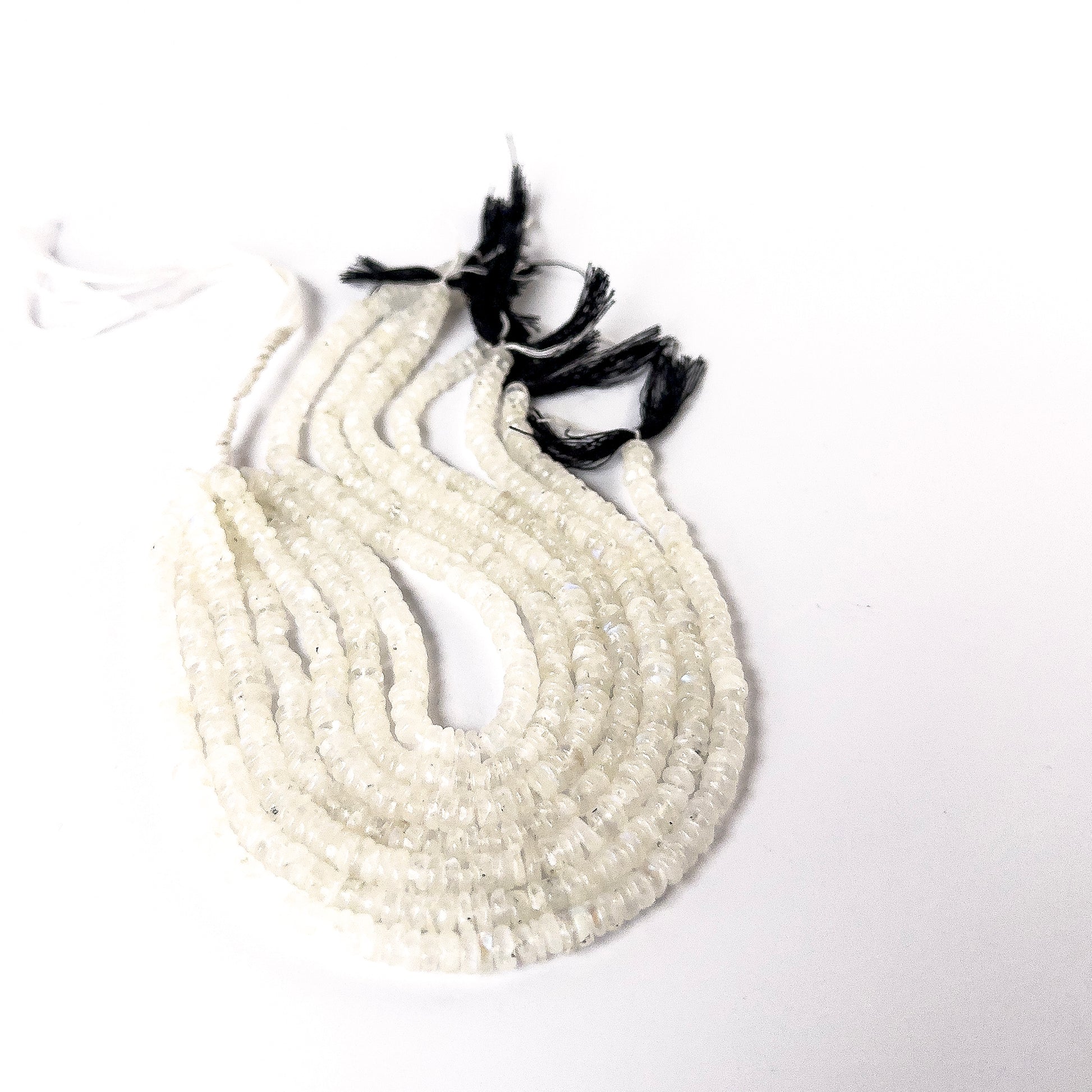Premium Moonstone wheel beads showcasing polished surfaces and natural iridescent glow.