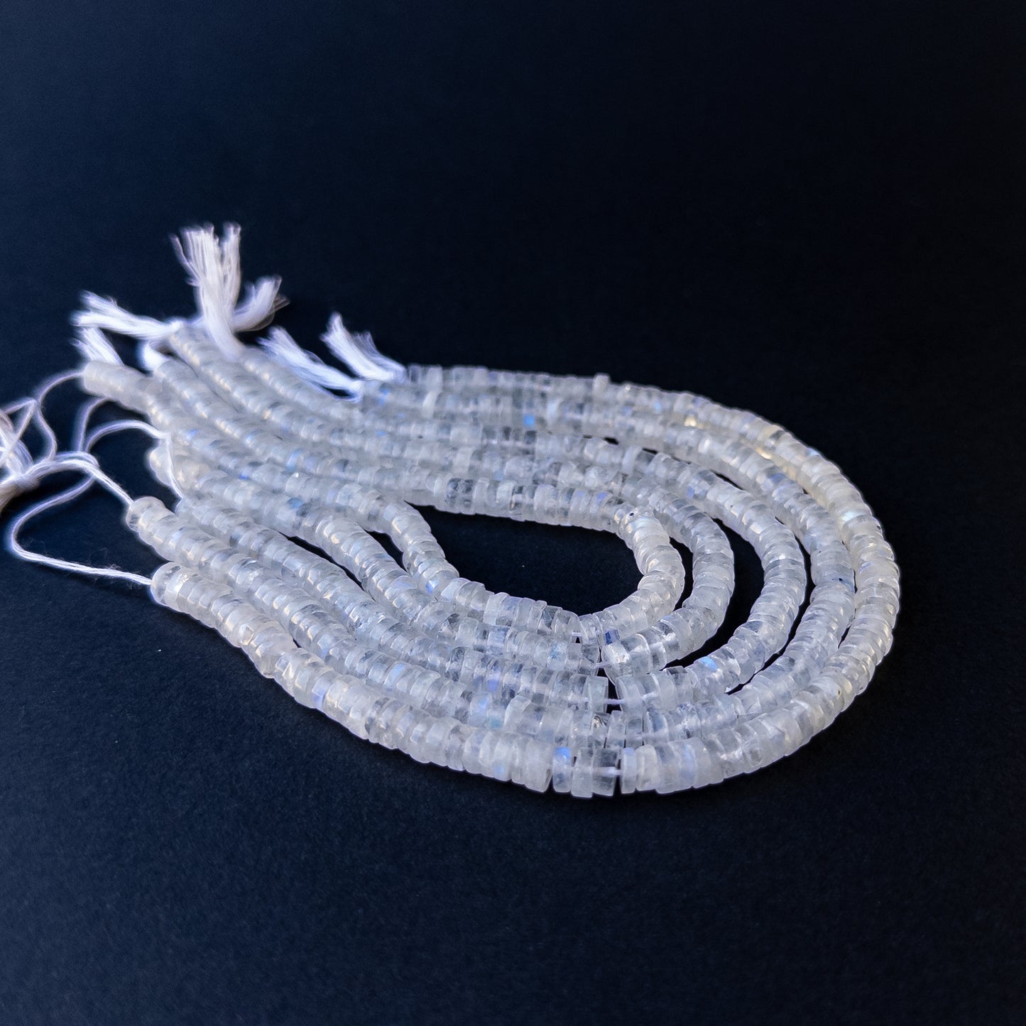 Genuine stone beads with soft white tones and rainbow flashes, featuring smooth wheels for DIY jewellery making.