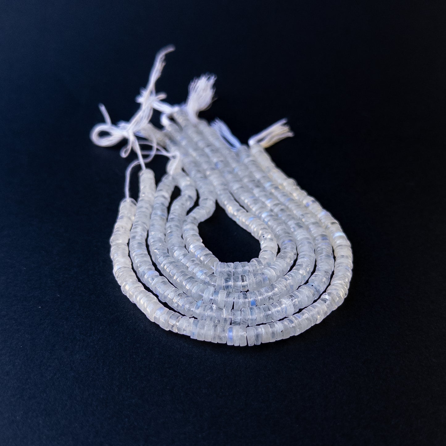 Handmade jewellery components featuring natural moonstone smooth wheels with luminous tones and polished glow.