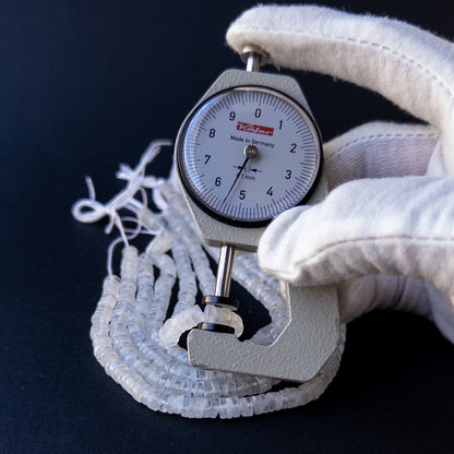 A dial gauge measures the Moonstone smooth wheel 5.5mm gemstone.