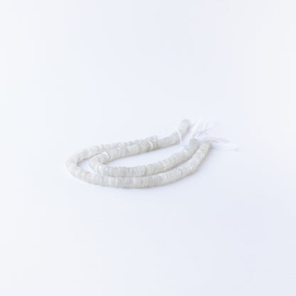 Close‑up of Moonstone smooth wheel beads showing their glow, clarity, and uniform arrangement.