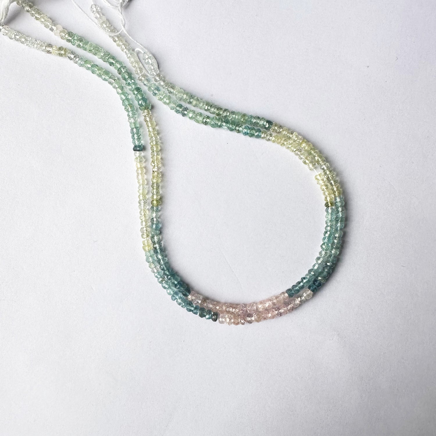 Glittering arrangement of Multi Aquamarine beads aligned in rondelle formation.