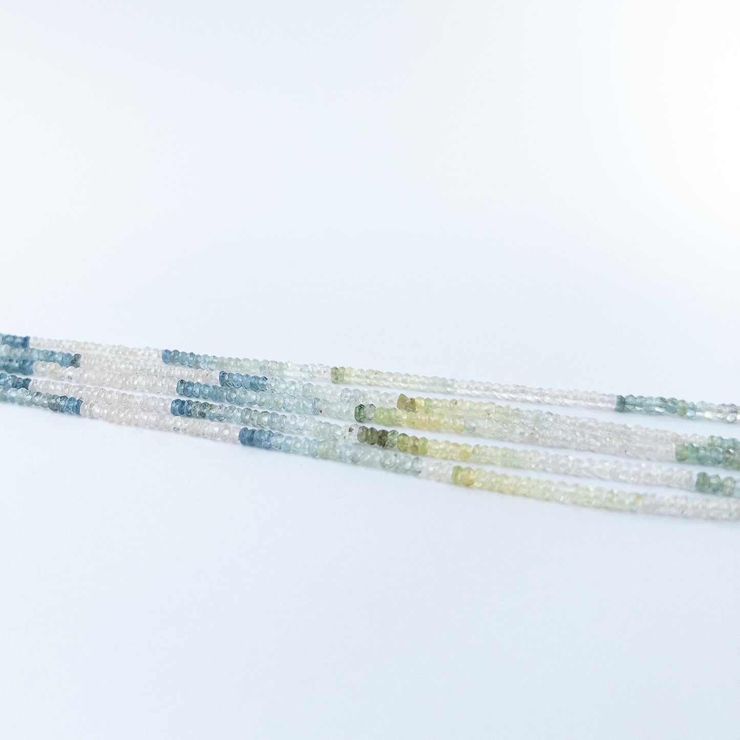 High‑quality Multi Aquamarine faceted rondelle beads in 3mm size offering brilliance and clarity for artisan jewellery projects.