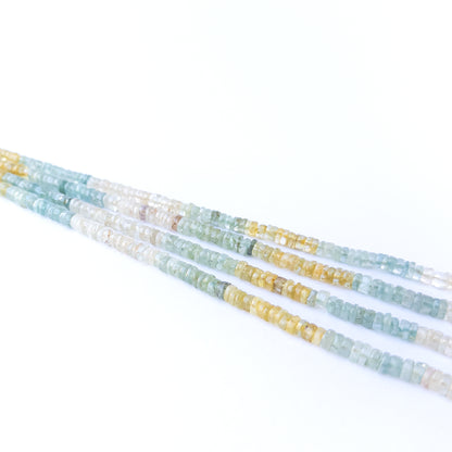 Close‑up of Multi Aquamarine smooth wheel beads showing their clarity, shine, and uniform arrangement.