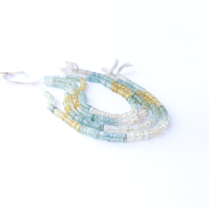 Genuine Multi Aquamarine smooth wheel stone beads showcasing their polished finish and ocean‑tone colours.