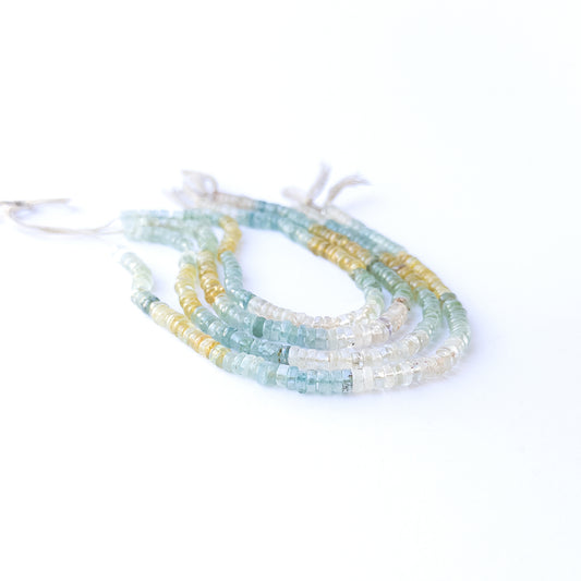Genuine Multi Aquamarine smooth wheel stone beads showcasing their polished finish and ocean‑tone colours.